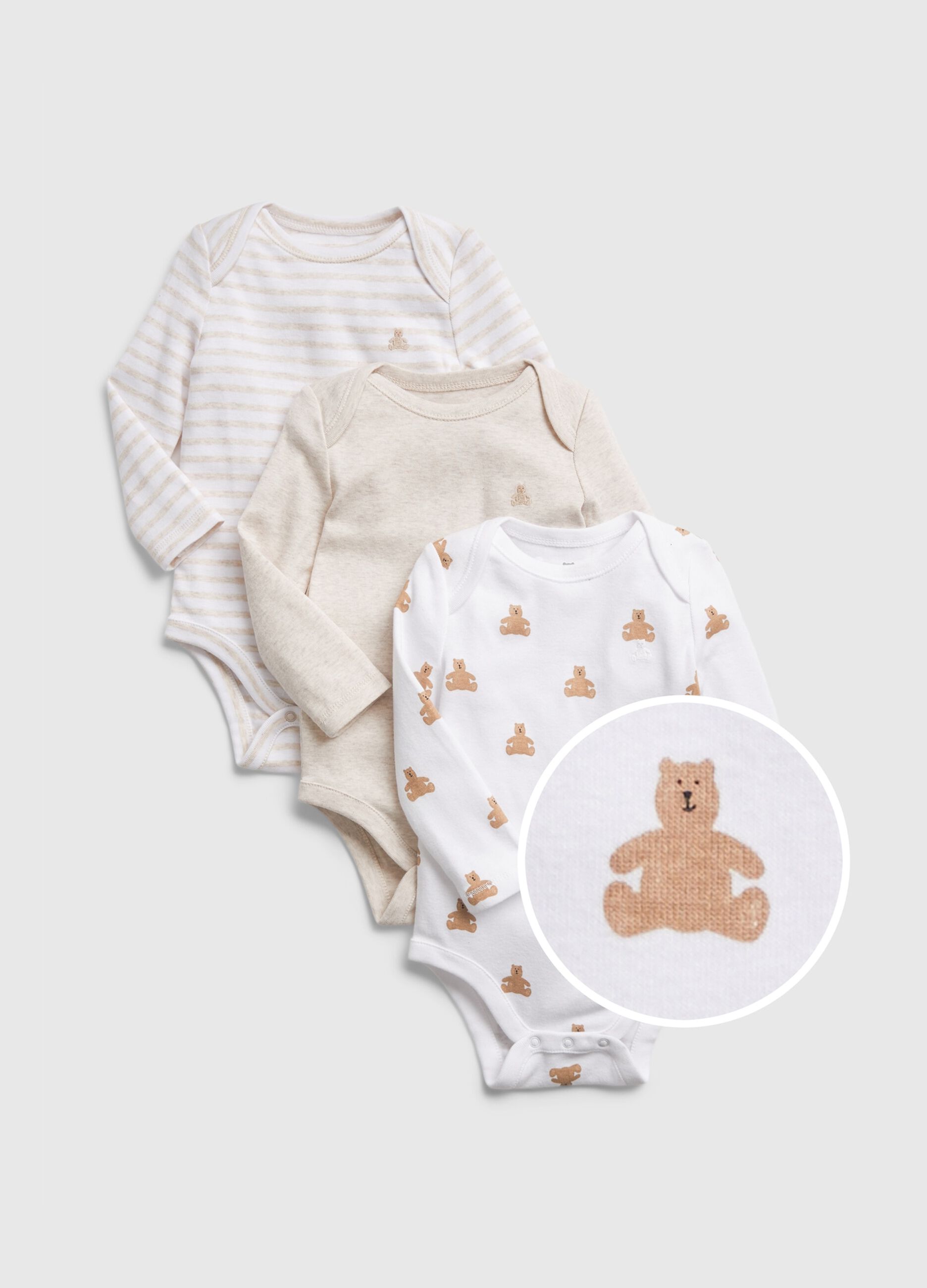 Three-pack cotton bodysuits with long sleeves.