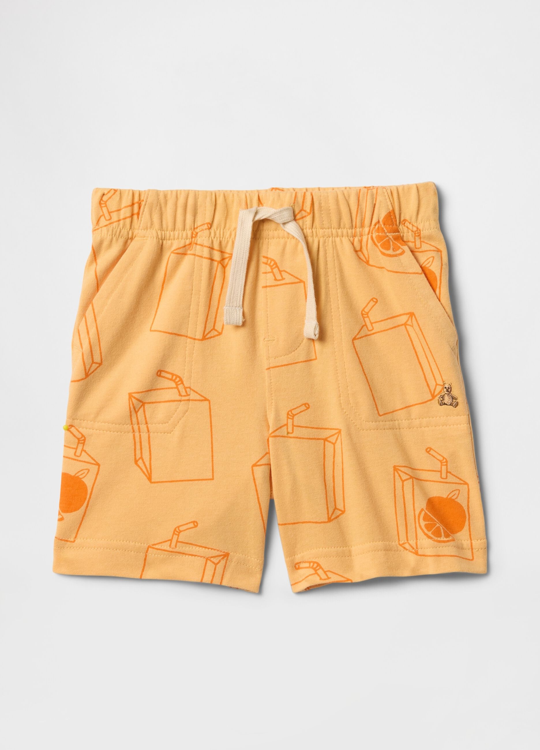 Pantaloncini arancioni con fantasia succo di frutta