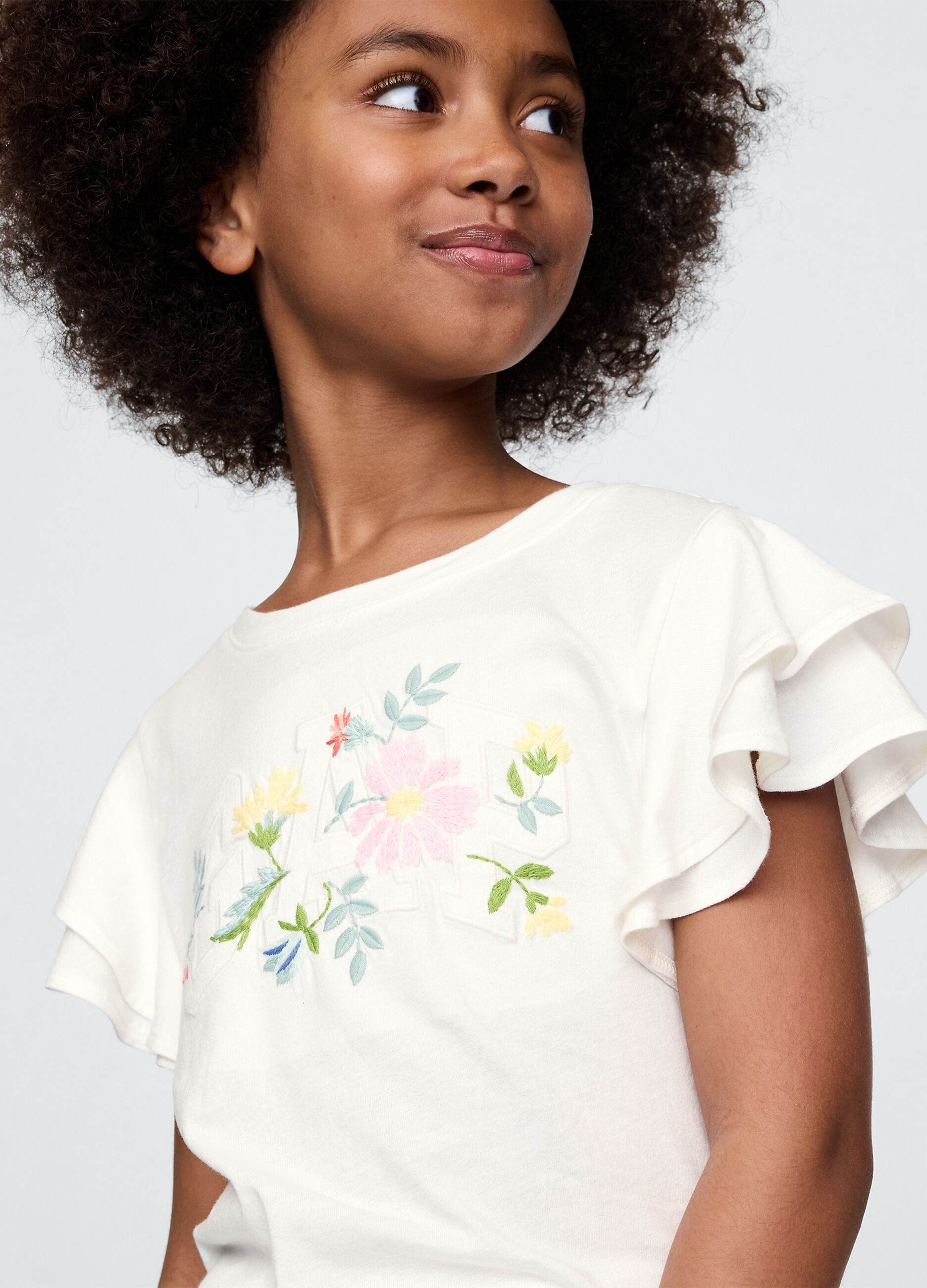 T-shirt a maniche corte bianca con volant e stampa floreale_2