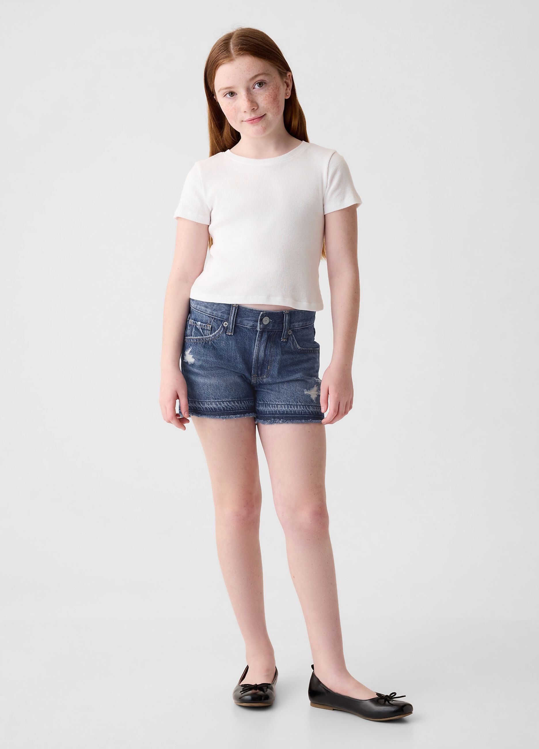 Shorts in denim con abrasioni a vita bassa